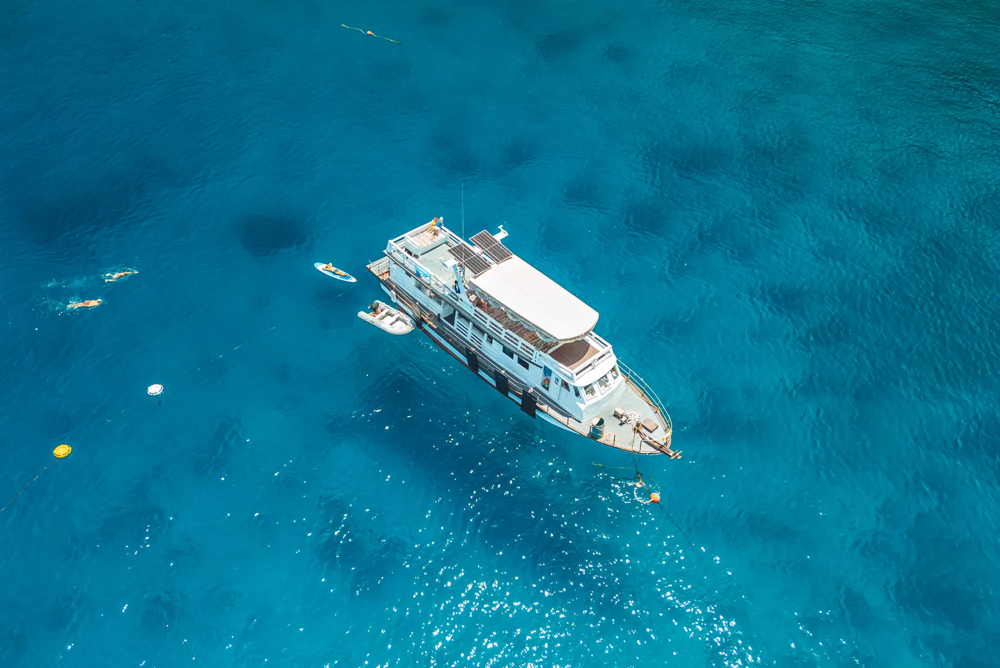 The Blue Chitta freediving boat anchored over turquoise water