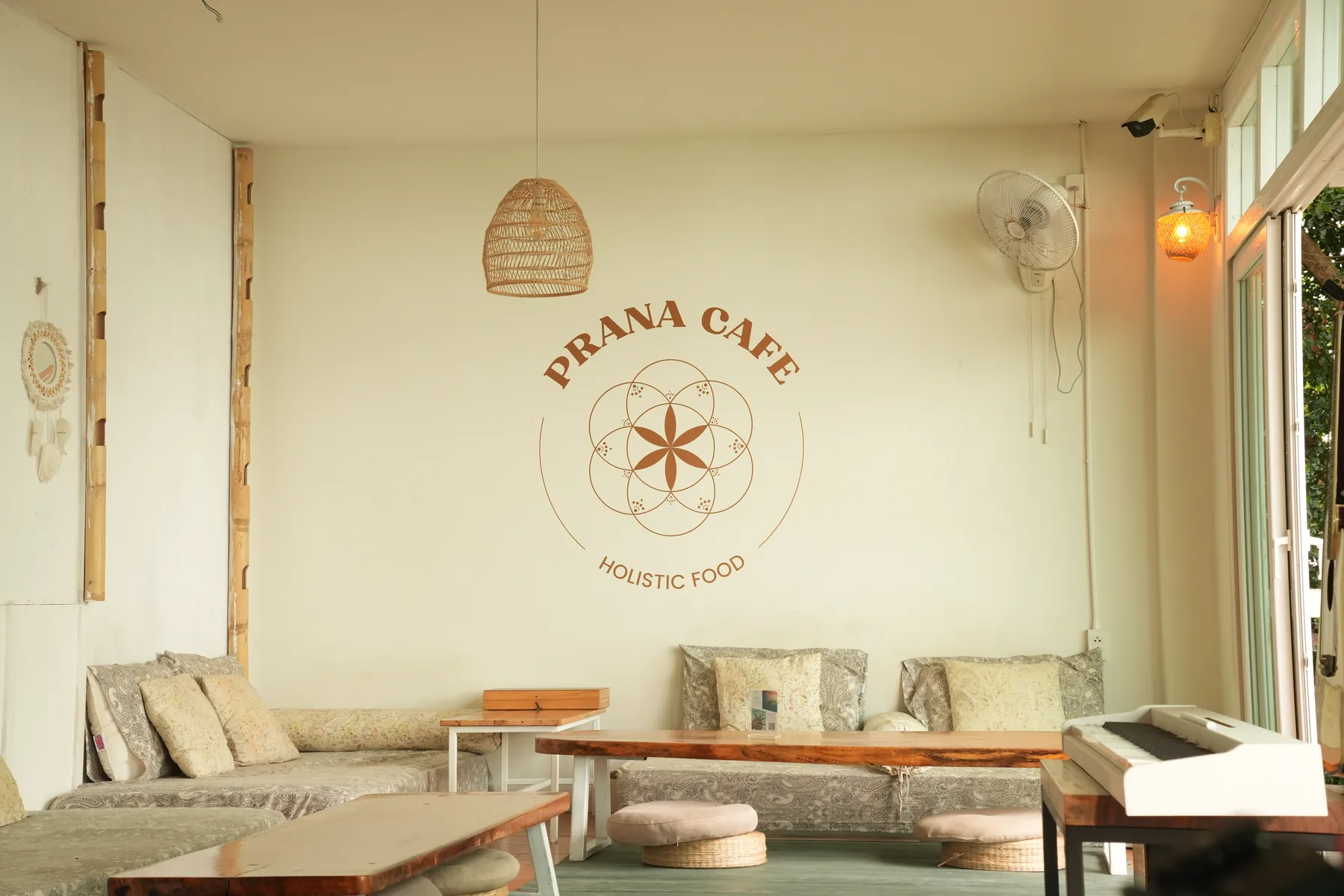 The Prana Café room with its painted sign and low seating